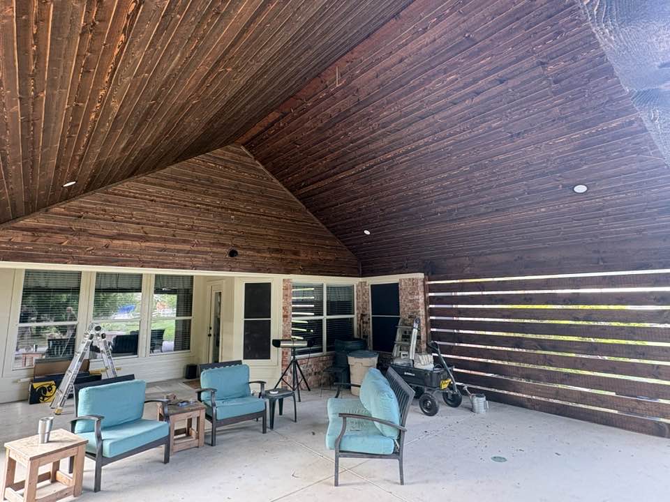Interior view — dark stained tongue-and-groove ceiling with teal chairs
